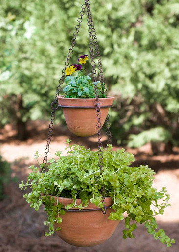 green rust two tier hanging planter with terra cotta pots light egg dishes