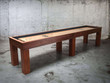 Full-length view of 12 foot Paula Parsons shuffleboard table in Natural Walnut