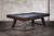 Three-quarter view of the Doc & Holliday George pool table in Antique Coffee on a concrete floor studio backdrop