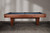 Full-length side view of the Doc & Holliday Preakness 8' slate pool table in walnut with maple racing stripes, photographed on the original photo shoot background.