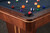 Angled overhead view of the playing surface on the Doc & Holliday Preakness pool table, showing felt texture, rail profile, and sight placement.