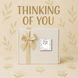 A white and tan Thinking of You Gift Box