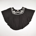 This is a Black Batwing Blouse with White Embroidered Accent, Size S.