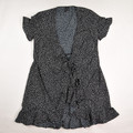 This black and white polka dot dress with tie and ruffle by Vero Moda is a size S.