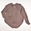 This brown, sheer blouse by Free People has lace accents, and is a size S.