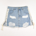 This women's distressed denim skirt by Forever 21 has lace-up sides, and is a size 27.