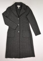 This grey and black long knit coat by Nine West has purposefully ragged hems, and is a size M.