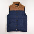 This is a blue puffer vest with brown corduroy accents by J. Crew, Size XS.
