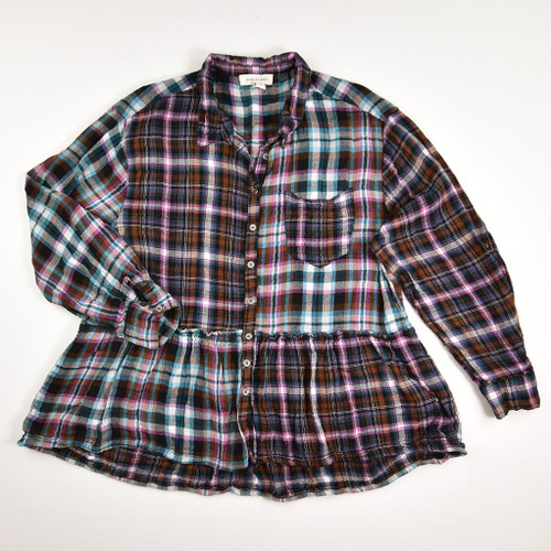 This women's plaid flannel shirt has a peplum bottom, is a size L, by Vintage America.