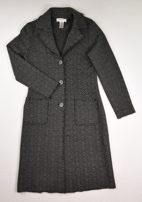 This grey and black long knit coat by Nine West has purposefully ragged hems, and is a size M.