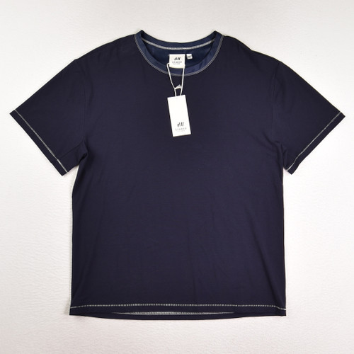 This is a blue, short sleeve knit shirt by H & M Studio, Size S.