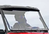 Front view of the SuperATV flip-out windshield closed on a red Polaris Ranger 570 Mid-Size, driver seated inside