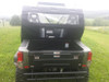 Side X Side cab enclosure rear panel on a Bennche X2 LT seen from behind the cargo bed, clear rear window above the tailgate