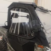 Close-up of the Side X Side enclosure front door window and mirror cutout on a Massimo T-Boss cab