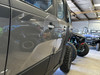 Dirty Teeth Racing billet aluminum exterior door handles installed on a gray Polaris Xpedition, side view in a shop
