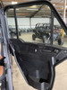 Inside of an open Can-Am Defender door with the Dirty Teeth Racing power lock fitted, shop in background