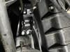 Close-up of the Dirty Teeth Racing billet lift bracket mounted on the Can-Am Defender frame with two bolts