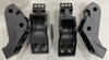 Four Dirty Teeth Racing Defender lift kit brackets standing on white, two tall rear and two front pieces