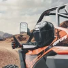 SCM mirrors for 1.75"-2.00" round roll cages: side mirror on an orange UTV roll cage, rider giving thumbs up