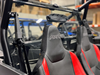 Spike rear windshield for Polaris RZR XP 1000 and XP 4 1000: rear windshield behind red Polaris RZR seats, indoor shop view