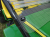 Extreme Metal Products windshield lower edge with rubber seal resting on the John Deere Gator hood, close-up