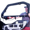 Person lifting a Seizmik framed upper door with clear window onto a Polaris General lower door