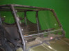 Trail Armor Cool Flo windshield installed on a Polaris Ranger in a showroom, front view against a green wall