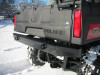 Extreme Metal Products black steel rear bumper installed on a red Polaris Ranger mid-size, rear quarter view in snow