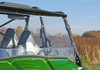 Side view of the SuperATV full windshield and cage clamps on a green Kawasaki Teryx with a roof