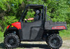 Full side profile of the red Polaris Ranger 570 with the SuperATV half door closed and driver in a helmet