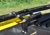 Close-up of the hood-mounted hinge bracket and latch hardware of the SuperATV flip up windshield
