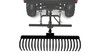 Straight rear view of the Kolpin Dirtworks 60-inch landscape rake on its lift frame behind a faded ATV outline