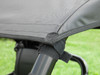 Close-up of the 3 Star cab enclosure roof corner strapped to the CFMoto UForce cage tube