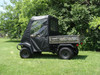 3 Star full cab enclosure with soft doors, top and rear window on a camo Kawasaki Mule 3010, side view on a lawn