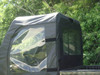 Close-up of the 3 Star cab enclosure side door and rear window on a Kawasaki Mule 3000/3010, rear angle