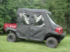 Driver side front three-quarter view of the red Kawasaki Mule 4010 Trans with the 3 Star soft cab