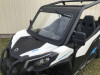 Extreme Metal Products laminated glass windshield with wiper on a white Can-Am Maverick Trail, front three-quarter view