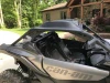 Extreme Metal Products Cooter Brown aluminum roof on a silver Can-Am Maverick X3, side view by a house