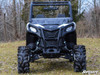 SuperATV 4-inch portal gear lift on a black and white Can-Am Maverick Trail with mud tires, front view in a field