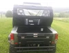 Straight rear view over the cargo bed of the Odes Dominator X2 LT showing the Side X Side enclosure rear window panel