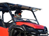 SuperATV scratch resistant flip windshield tilted open on a red Honda Pioneer 1000, side view with rider