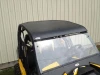 Front view of the Extreme Metal Products aluminum top over the tinted windshield on the yellow Can-Am Maverick