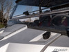 Close-up of the SuperATV flip windshield lower edge and rubber seal meeting the hood of a silver Yamaha Wolverine