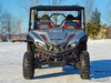 Straight front view of the gray four-seat Yamaha Wolverine with the SuperATV half windshield on snow