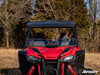 Straight front view of the red Honda Talon 1000 showing the SuperATV half windshield under the roof