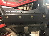 Close-up of the Trail Armor side skid plate installed along the rocker below the Honda Talon door graphics