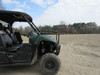 Side view of a green Yamaha Viking VI in a field showing the Seizmik hood rack mounted above the hood