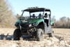 Front three-quarter view of a green Yamaha Viking VI in a field with the Seizmik hood rack installed