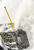 Kolpin yellow snow plow marker rod on the end of a plow blade, close-up as snow is thrown