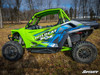 Side profile of a green Textron Wildcat XX in a field with SuperATV nerf bars fitted below the doors